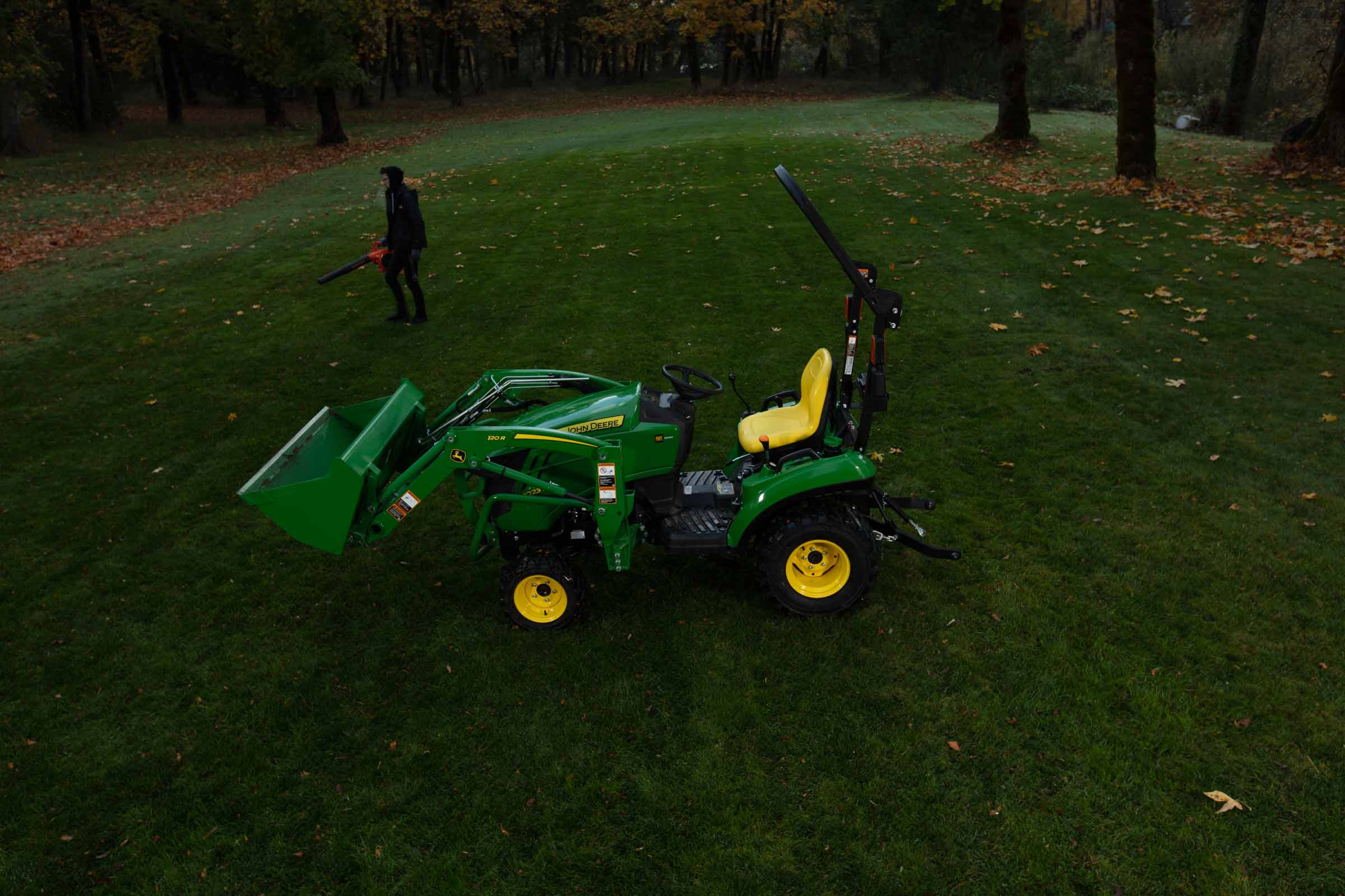 Compact tractor on lawn at dusk