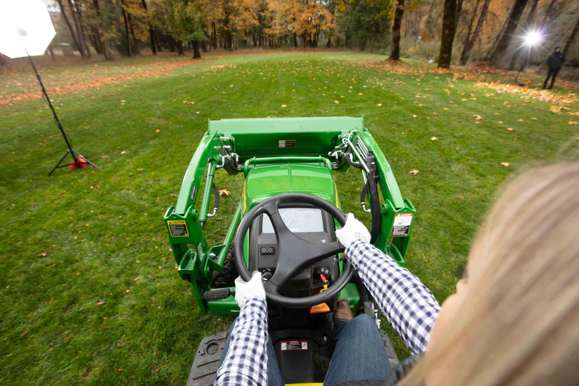 Driver's POV on John Deere tractor mowing