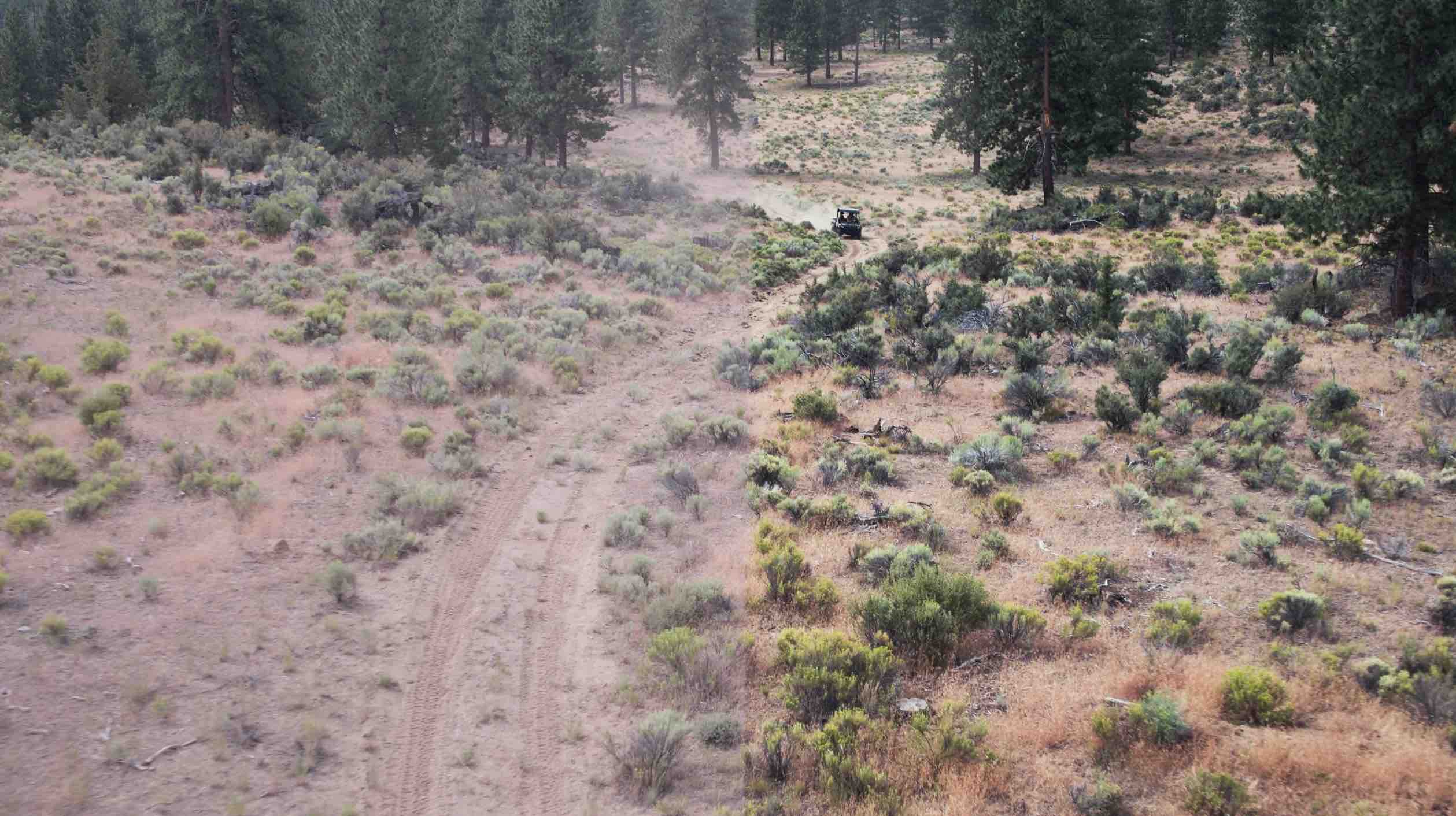 A graded aerial frame of a trail through high desert, from FPW’s colour reel