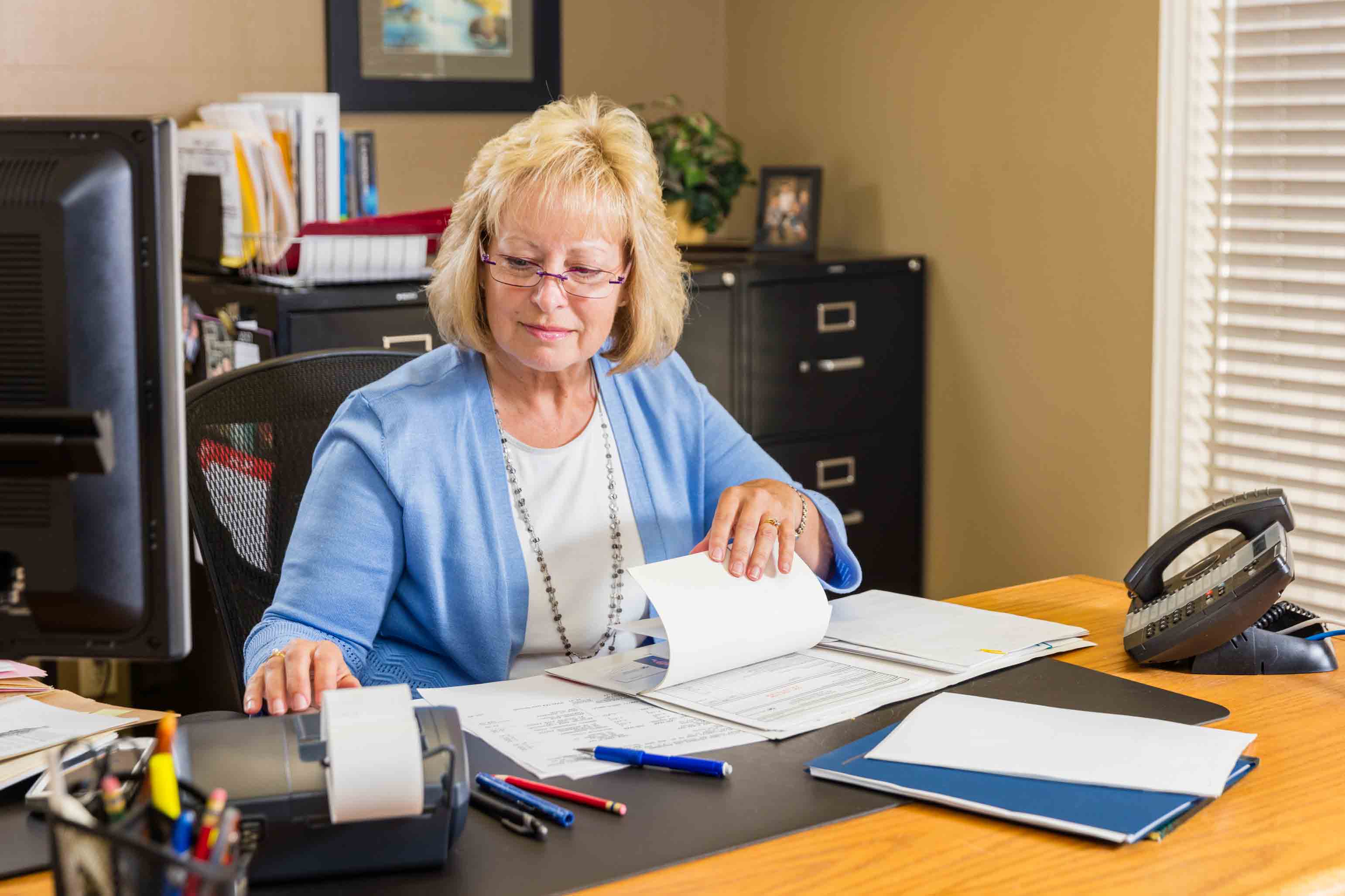 Accountant reviewing paperwork at office desk