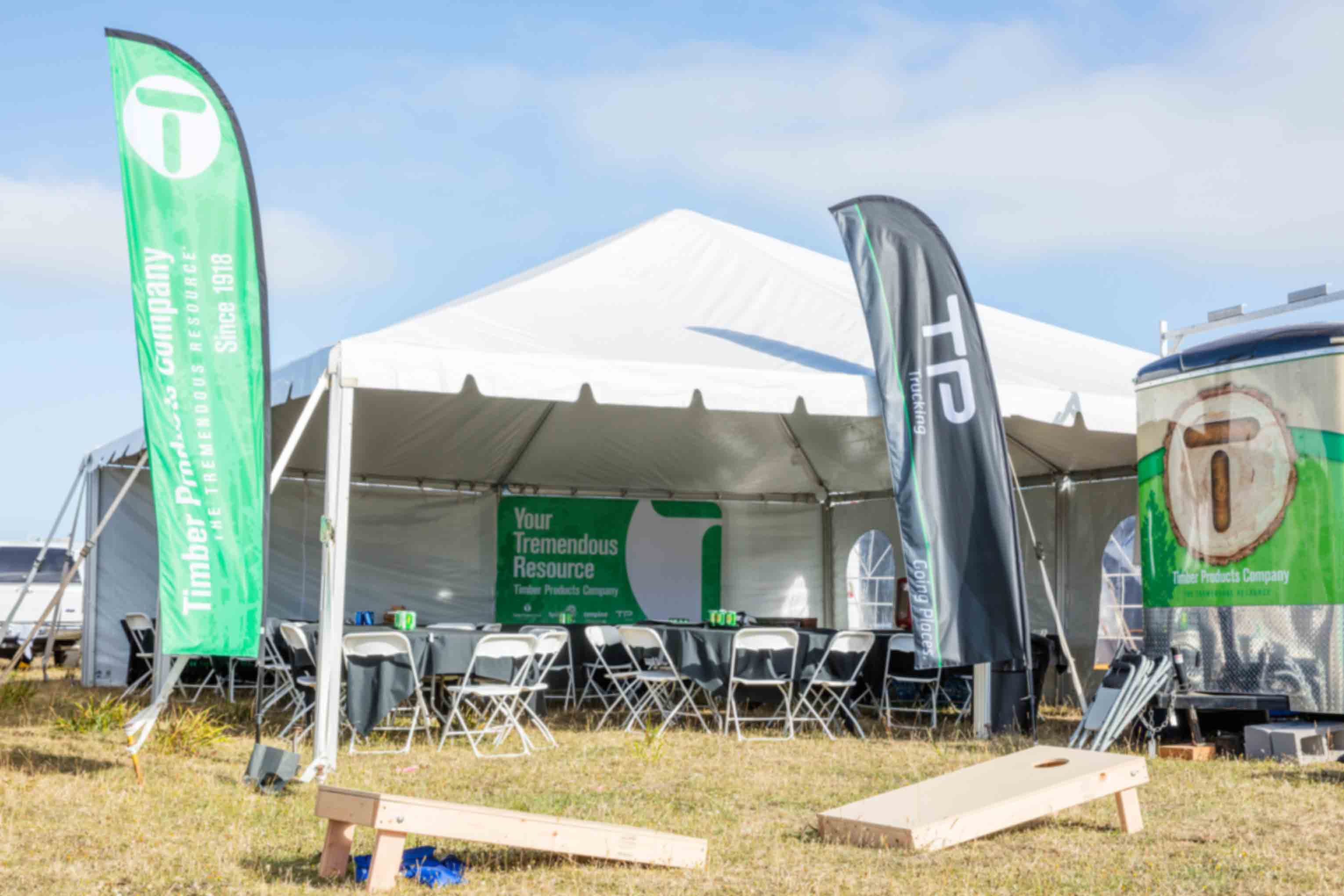 A branded festival tent with Timber Products flags
