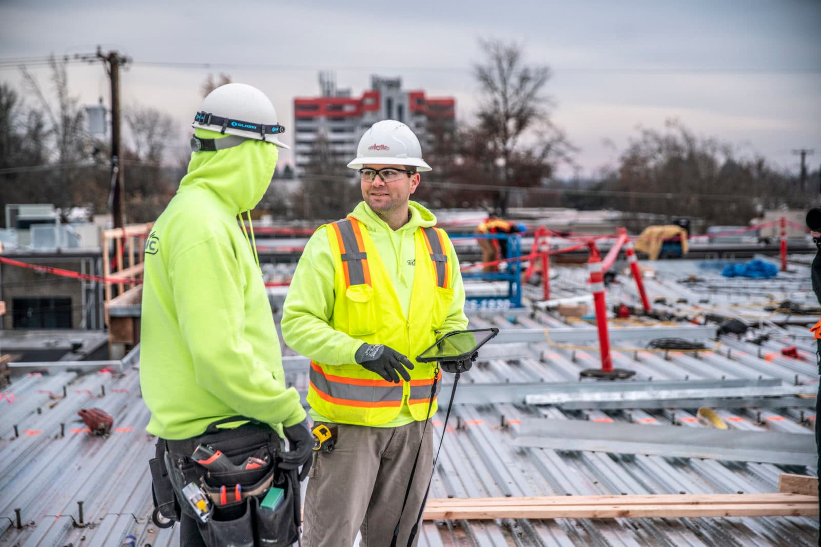 Hi-vis workers on metal roof deck