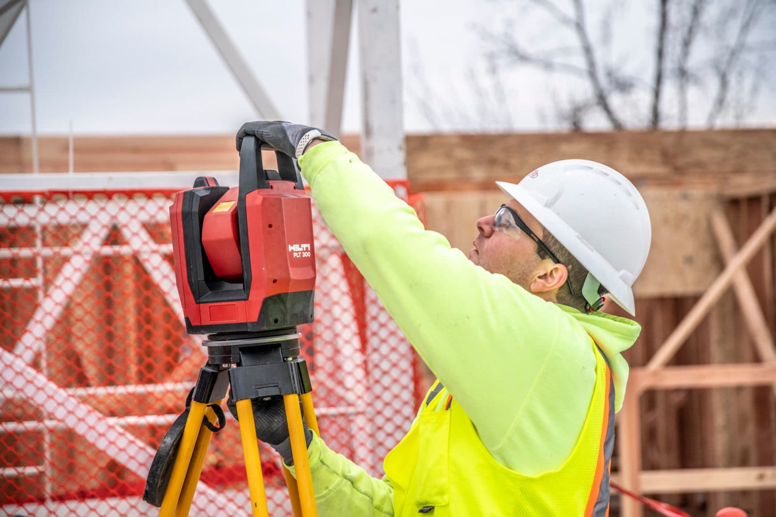 Worker setting up red Hilti layout tool