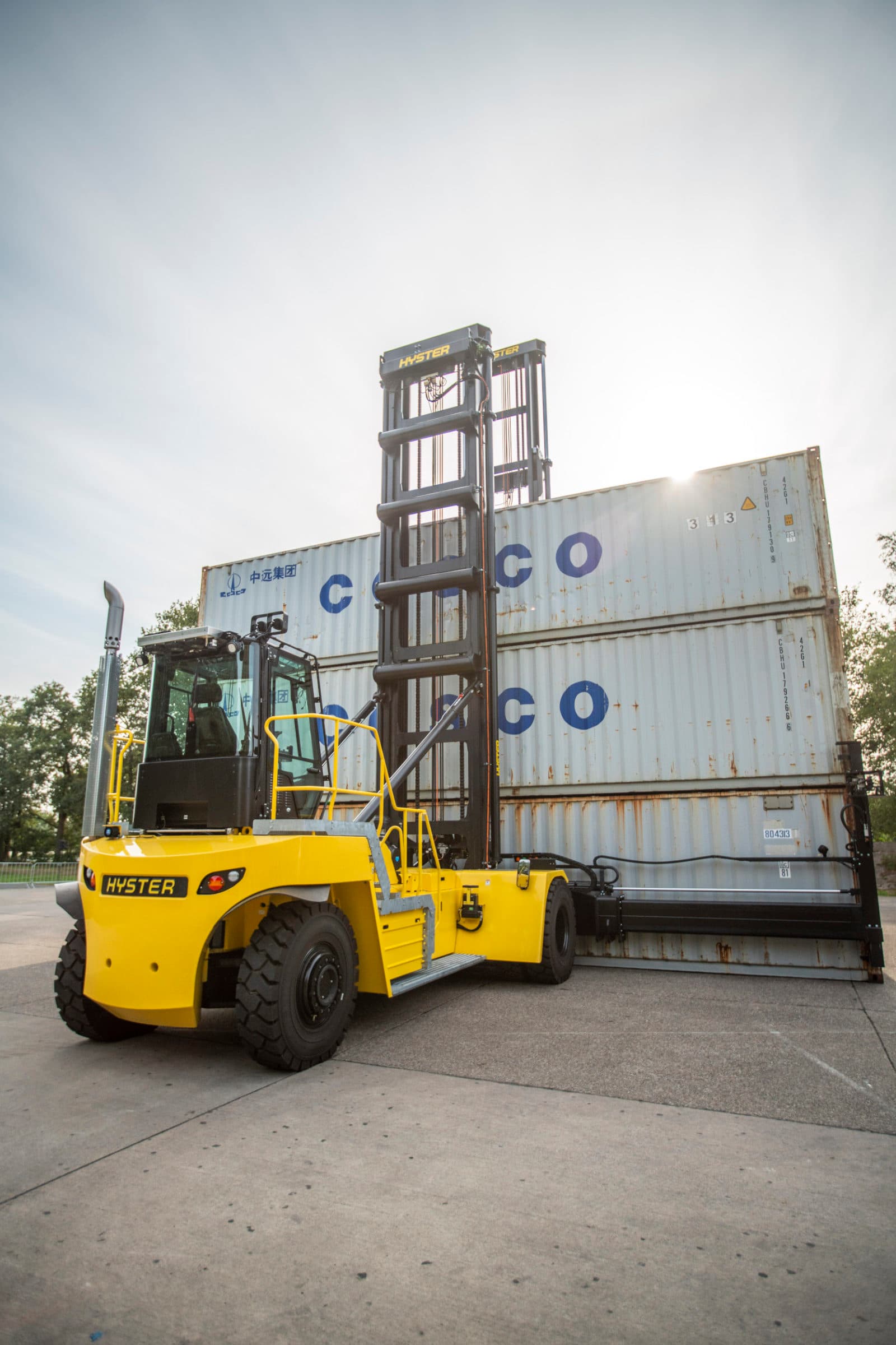 Yellow Hyster handler lifting COSCO containers