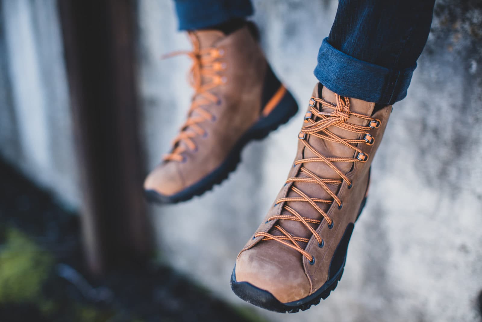 Close-up of tan hiking boots mid-air