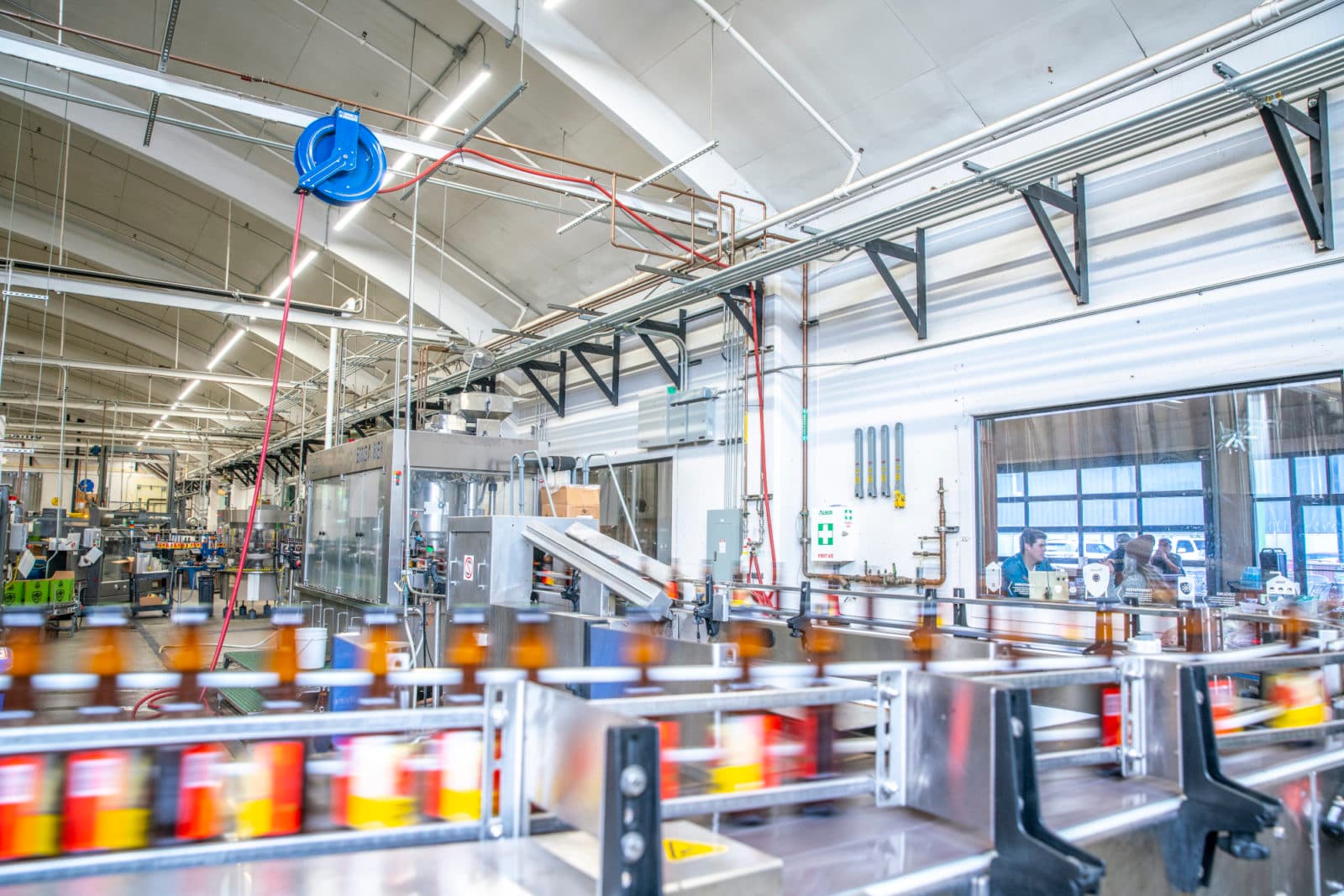 Colourful cans on brewery conveyor