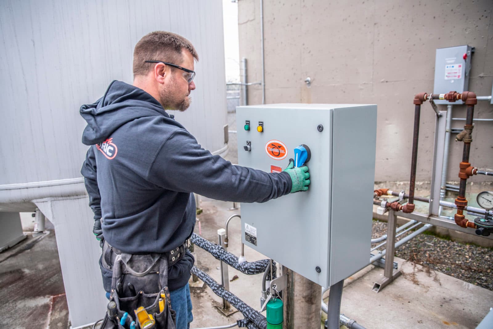 Technician pressing button on control box