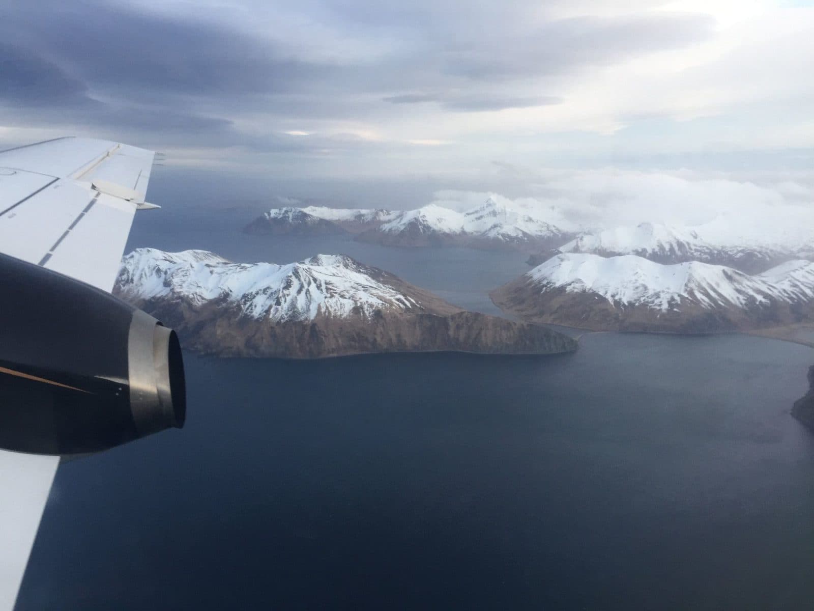 Snowy Alaska mountains from airplane window