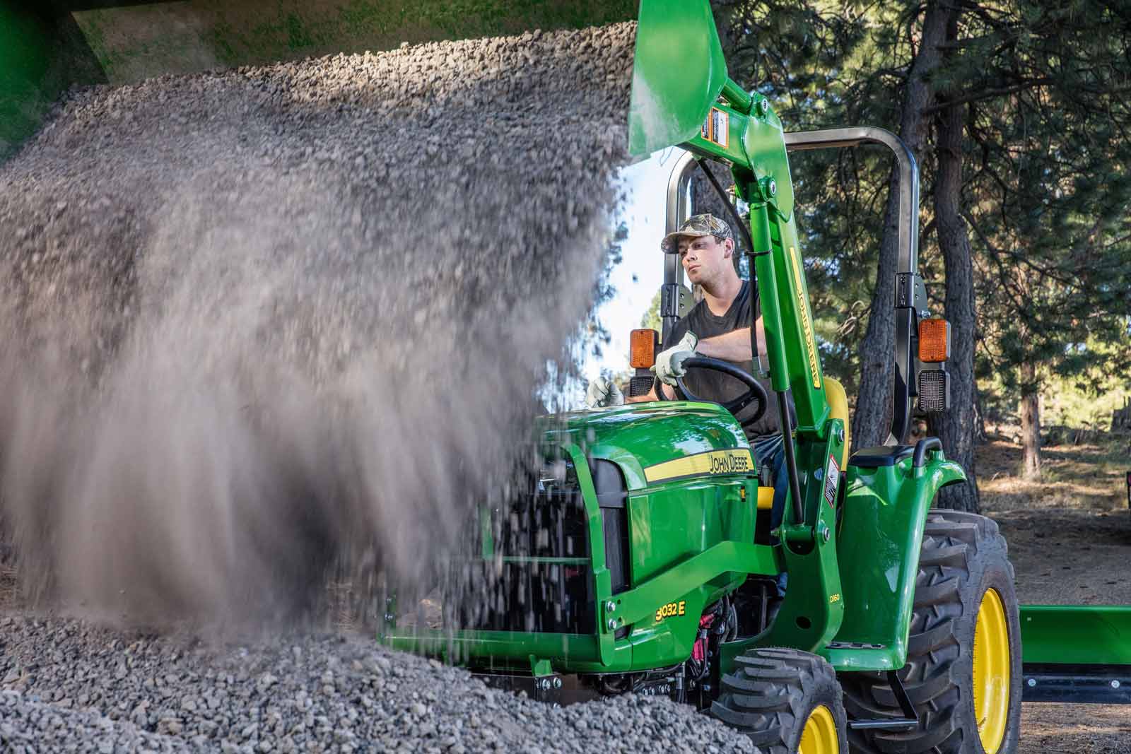 Tractor loader dumping gravel, motion