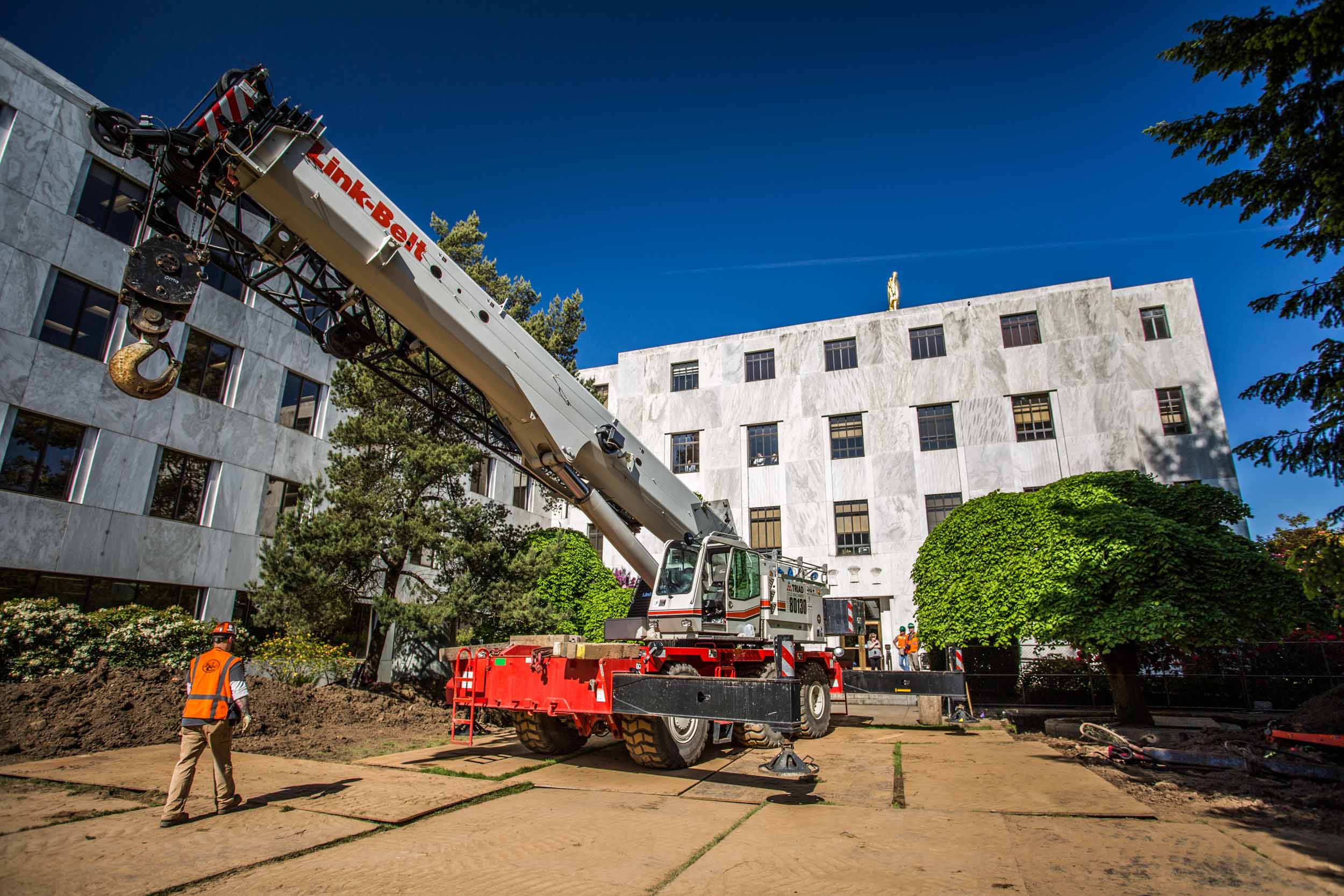 Mobile crane between white office buildings