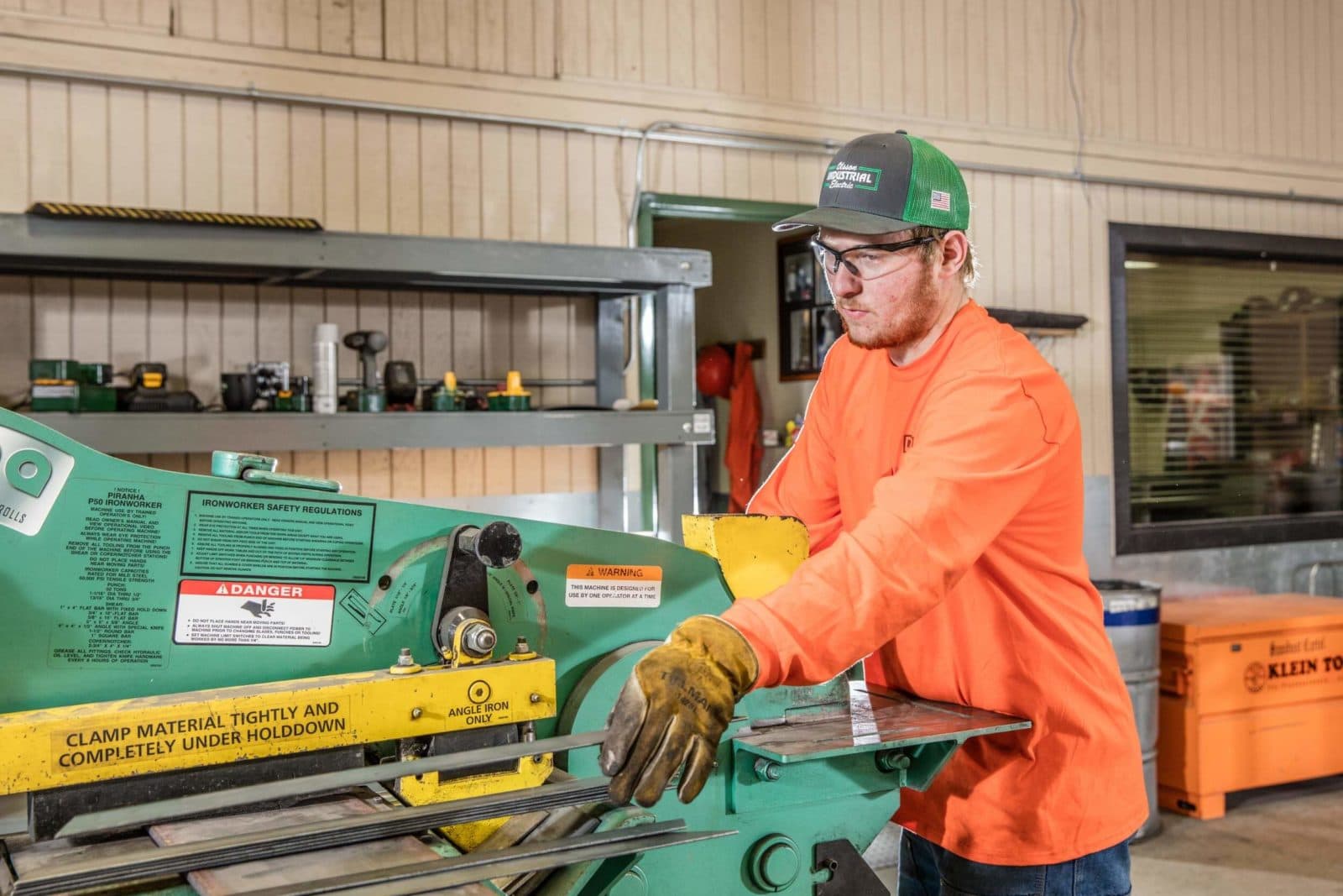 Fabricator operating green metal shear