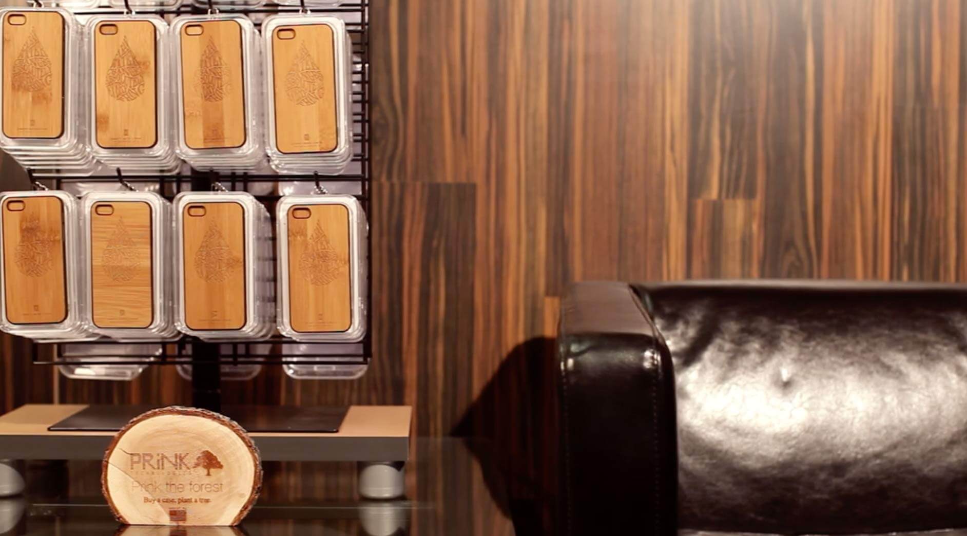 Wooden phone cases displayed on wood wall