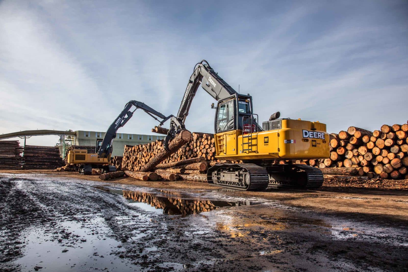 John Deere log loaders in mill yard