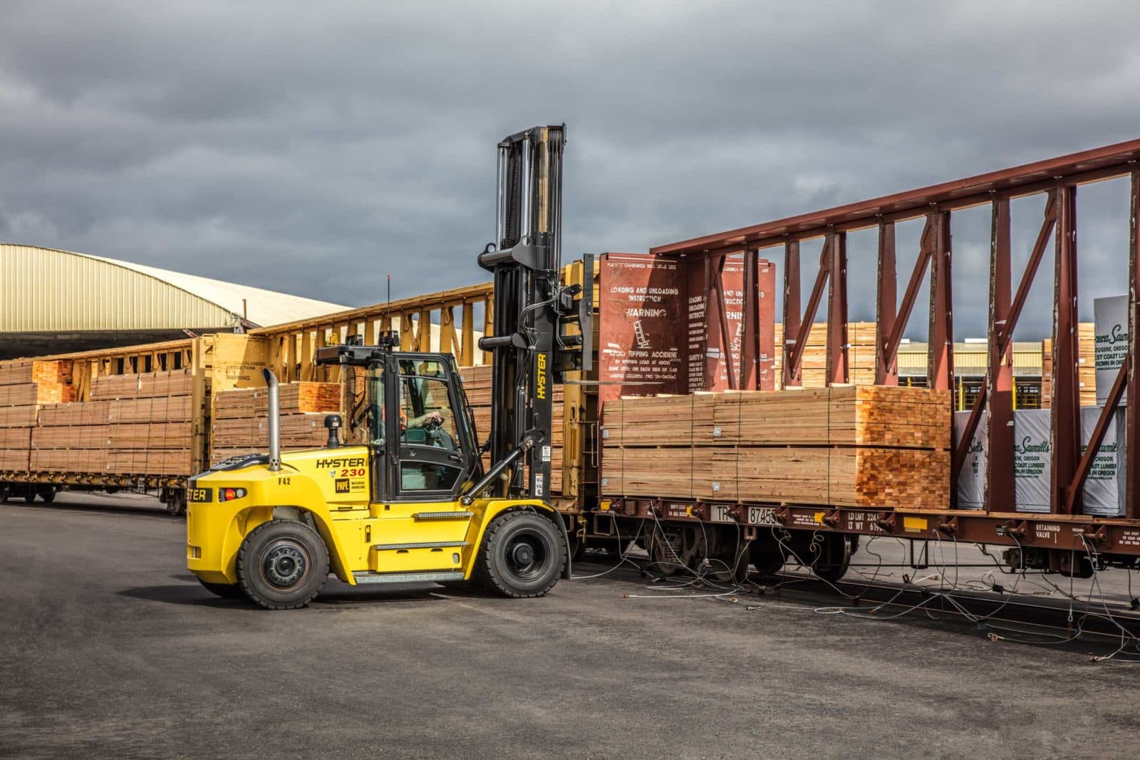 Forklift loading lumber rail car