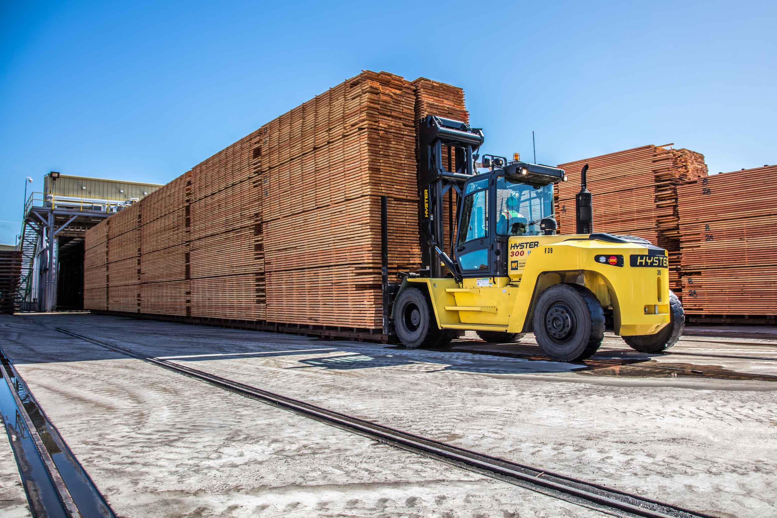 Forklift at lumber stacks on rail spur