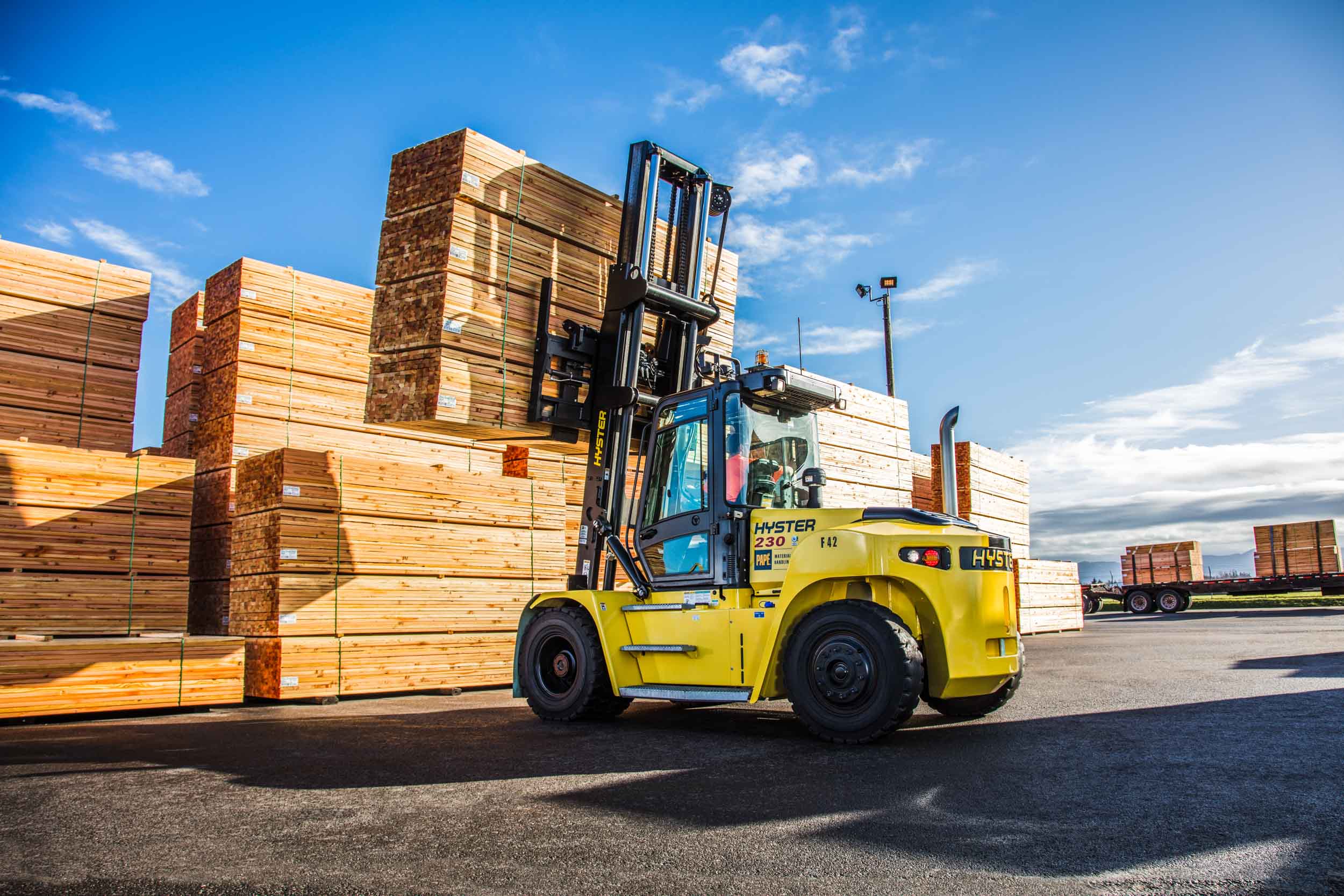 Yellow forklift in lumber yard