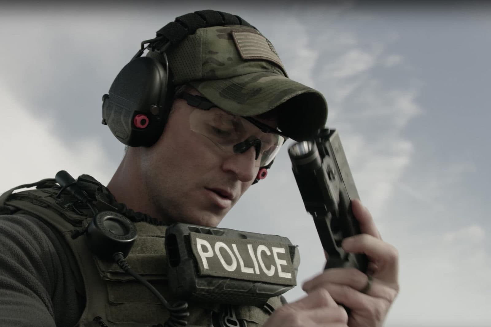 SWAT officer adjusting hearing protection