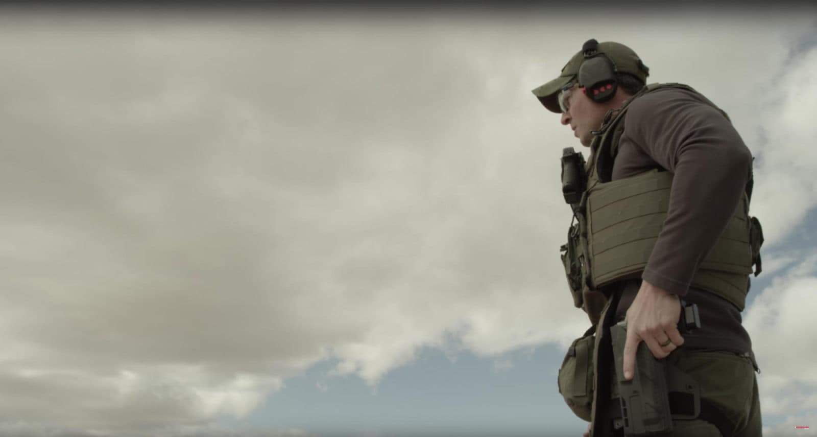 Officer silhouetted against clouds (wide)