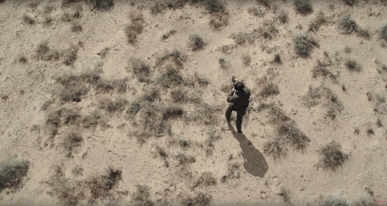 Top-down drone shot of officer in desert