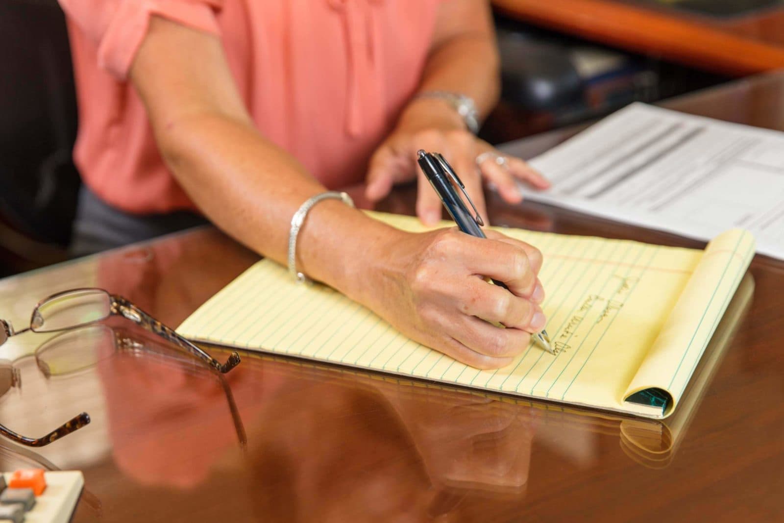 Hand writing on yellow legal pad