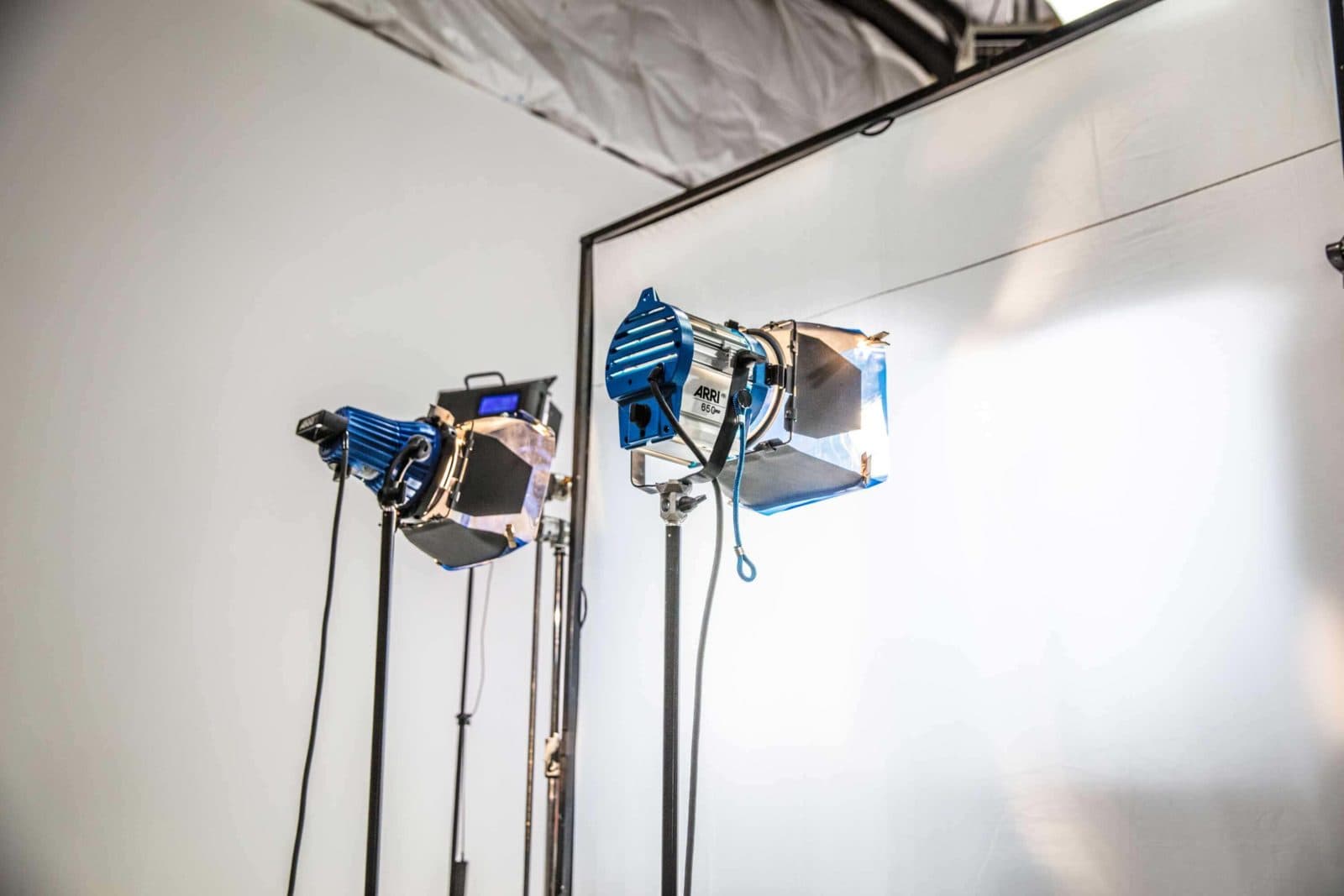 Studio lights set against FPW’s white cyclorama wall