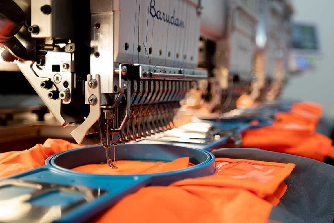 Barudan machine stitching orange hi-vis jackets