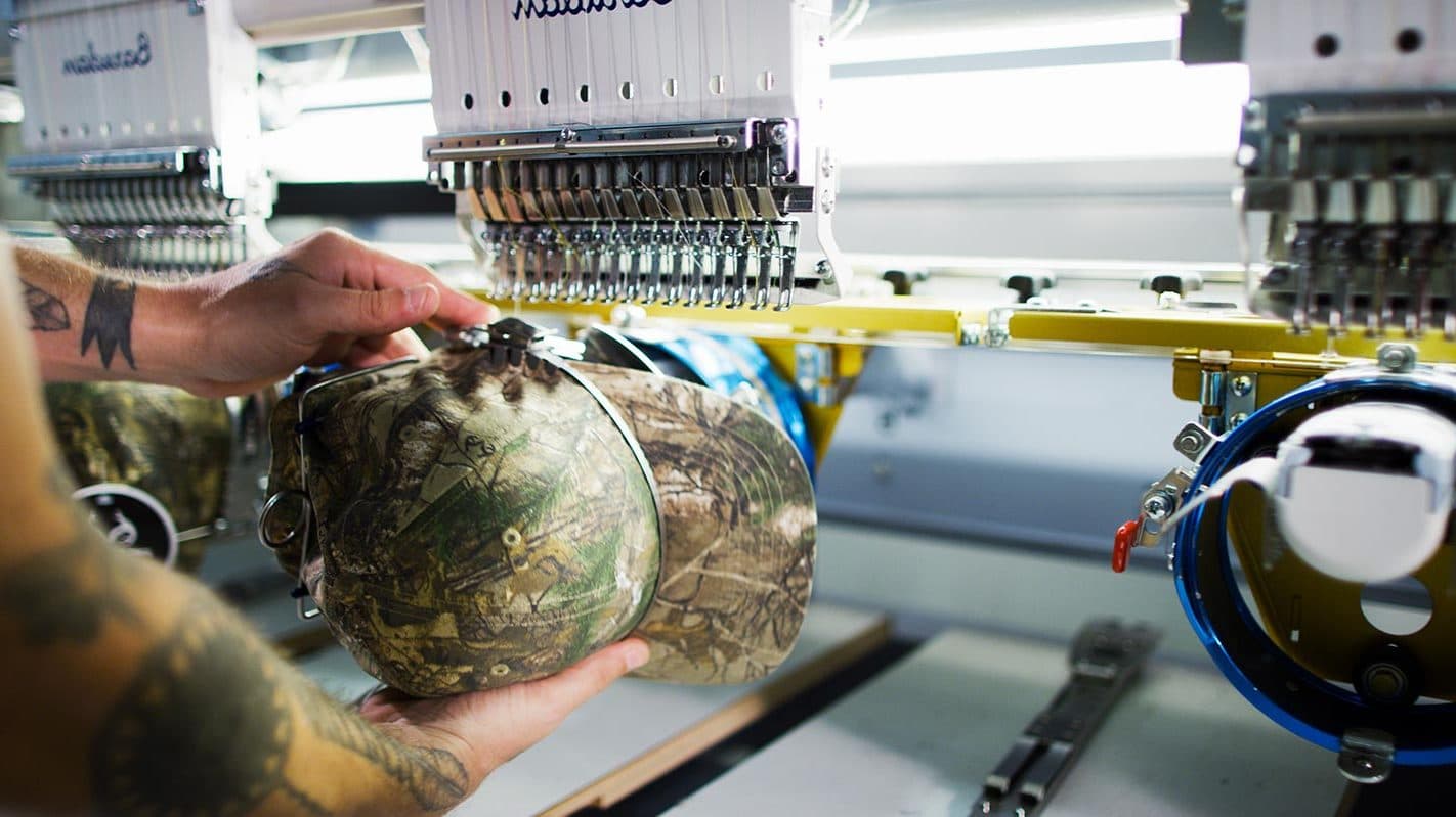 A camouflage cap being hooped for embroidery